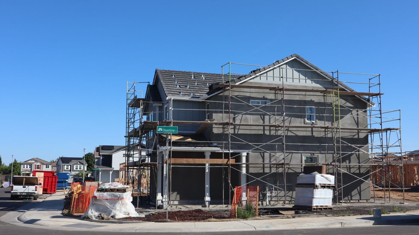 A new housing development under construction in elk grove, california with visible scaffolding and materials