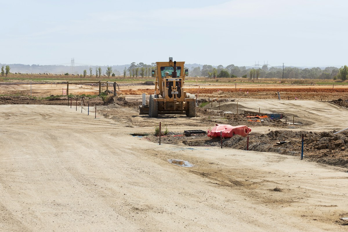A construction site with a bulldozer in the middle of it